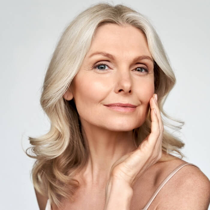 A mature woman with smoother skin because of laser treatment at Illustria